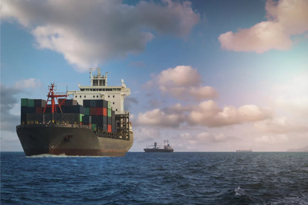 A freight boat with shipping containers in the ocean.