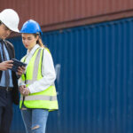 A customs officer inspecting cargo containers in a port container yard
