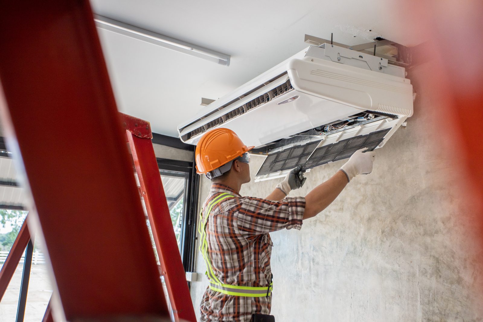 Residential HVAC installation by Bob's Heating HVAC technician preparing a new residential air-conditioning unit for installation.